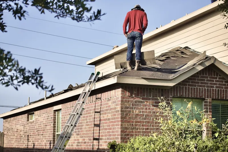 Professional roofer working on a residential roof in Russian Village